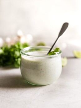 cilantro garlic sauce in jar with spoon inside the jar