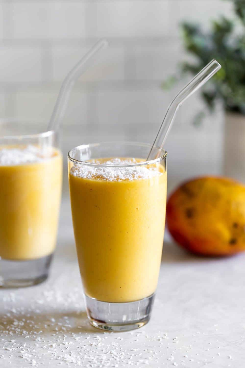 cuban mango shake made with coconut milk, mango, banana, shredded coconut flakes, and sweetened condensed milk