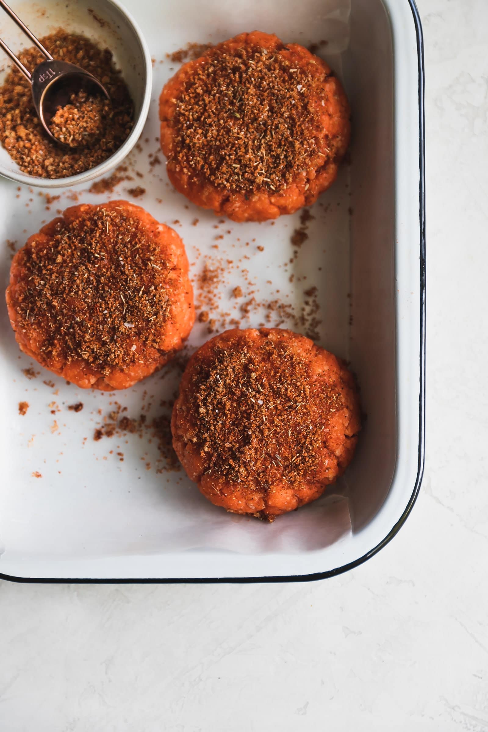 Easy-to-make, smoky, blackened salmon burgers made with smoked paprika, a pinch of cayenne, cumin, oregano and a queso fresco cream cheese spread!