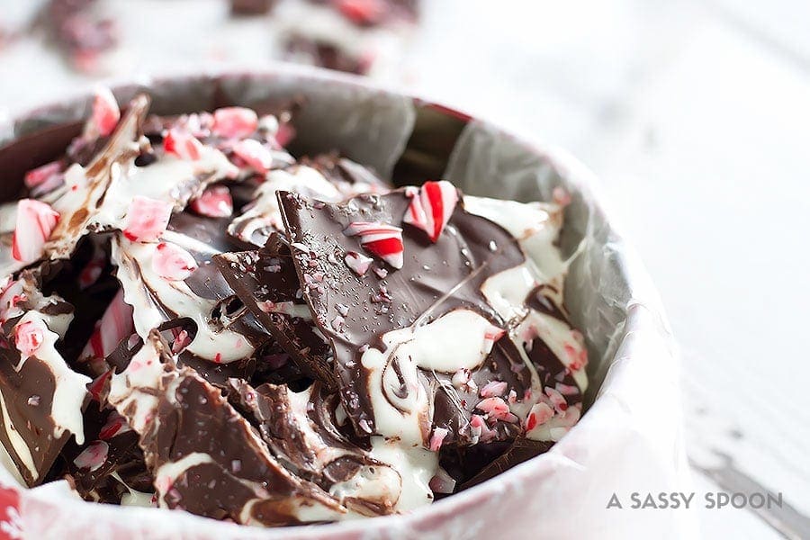 Sleigh the holidays with Boozy Marshmallow Peppermint Bark! Melted marshmallow mixed with peppermint schnapps, swirled on melted dark chocolate then topped with crushed candy canes.