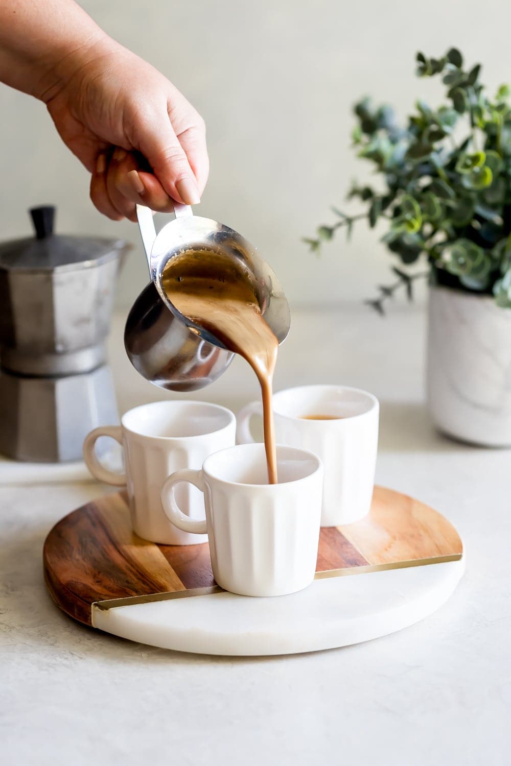 cuban coffee being poured into a espresso cups