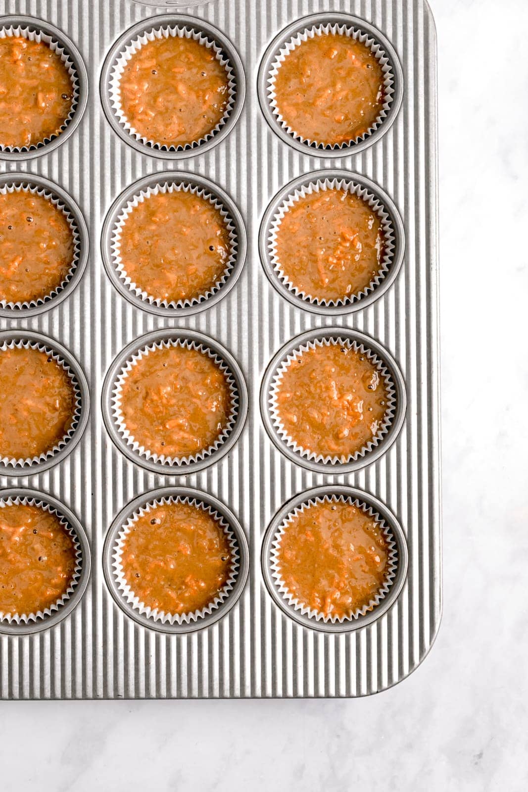 carrot cake cupcake batter in a muffin tin