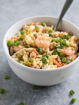 Forget takeout. Make Cauliflower Shrimp Fried Rice at home using riced cauliflower, carrots, peas, onions, garlic, and coconut aminos in just 15 minutes!