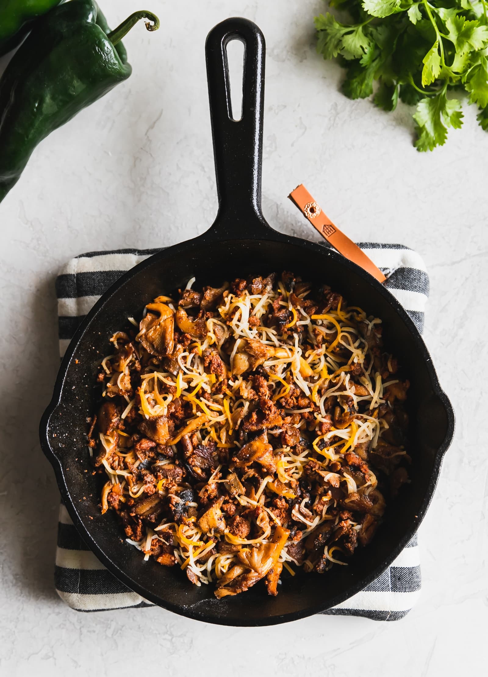 chorizo and mushrooms in a cast iron skillet