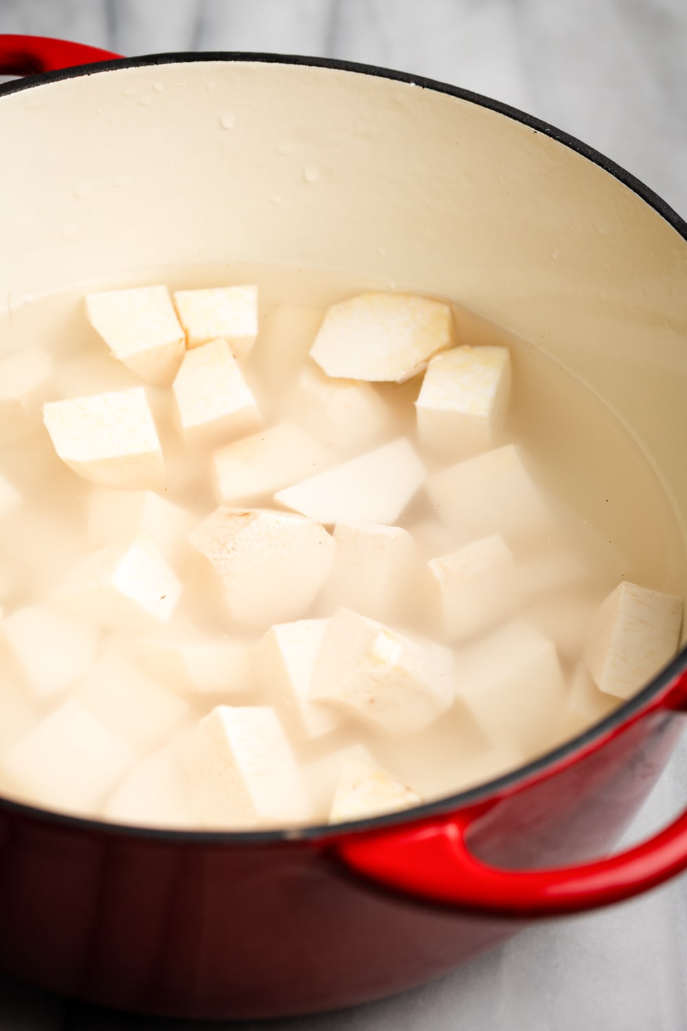 boiling the root vegetables in a Dutch oven until fork-tender