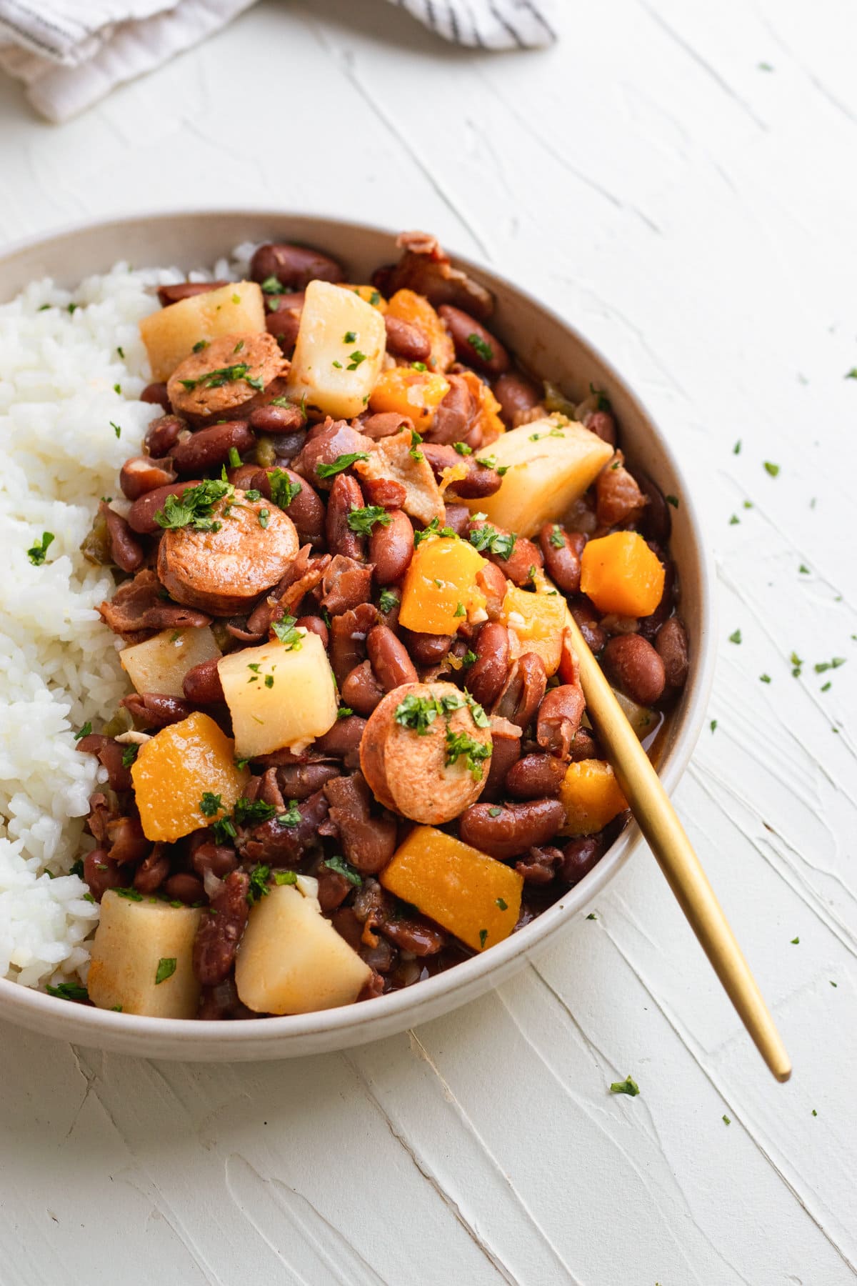 frijoles colorados served with white rice on a white plate