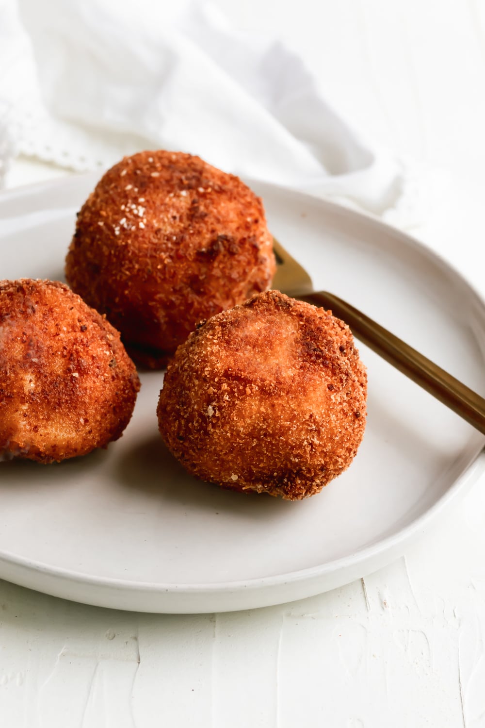 3 papas rellenas on a white plate