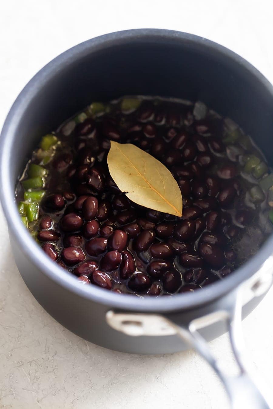 Cuban black bean recipe ingredients cooking in a pot