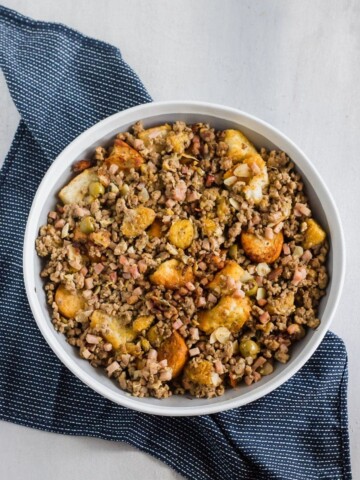 Cubes of toasty French bread mixed with ground beef, ground pork, diced ham, herbs, spices, sliced almonds, chopped olives, and sweet plantains! The BEST stuffing you'll ever try!