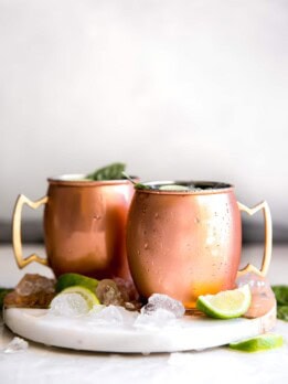 Guava Basil Moscow Mule. A twist to the traditional refreshing Vodka cocktail made with spicy ginger beer, guava nectar, fresh lime and sweet basil. Delicious drink for any time of year!