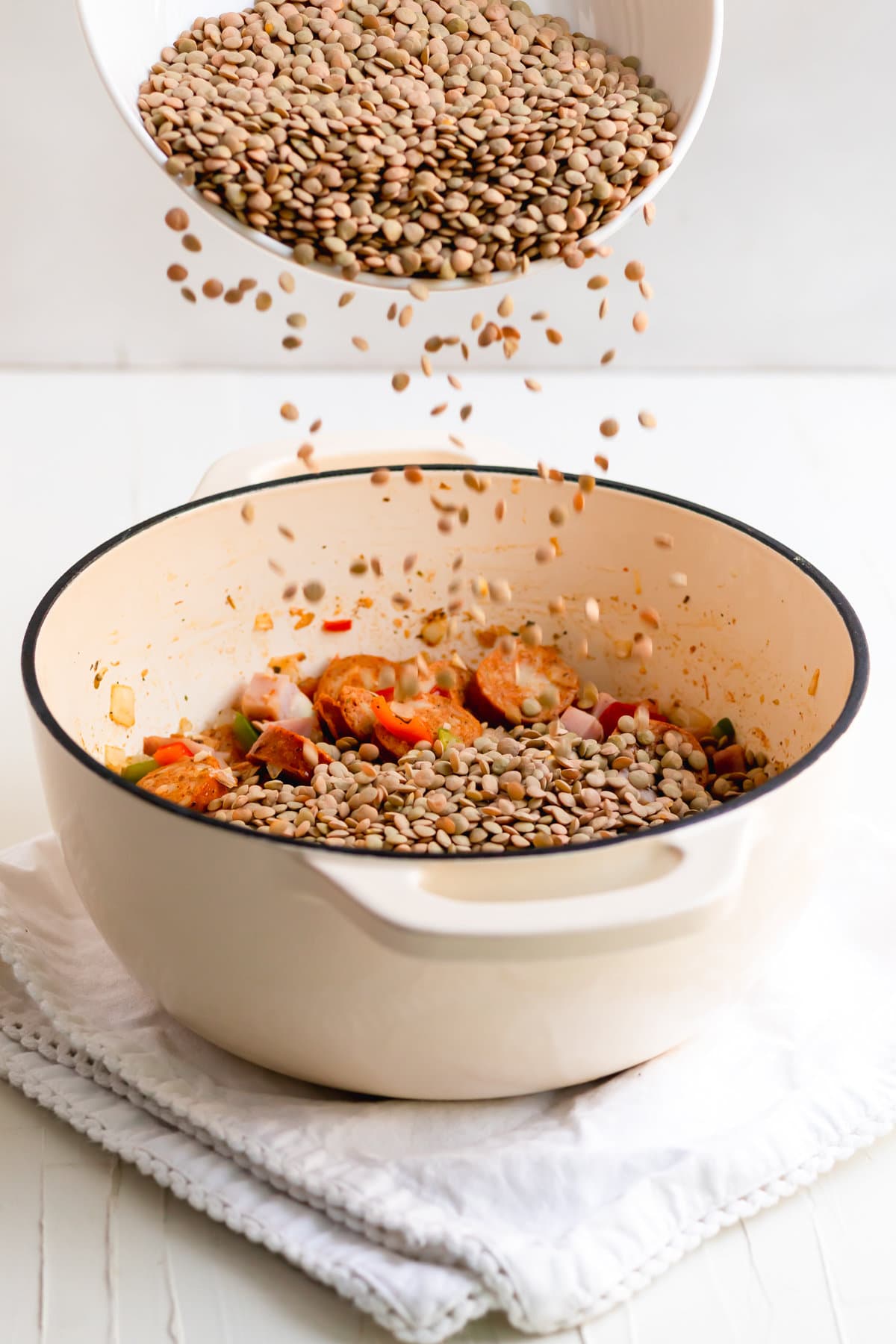 Adding the brown lentils to the potaje de lentejas