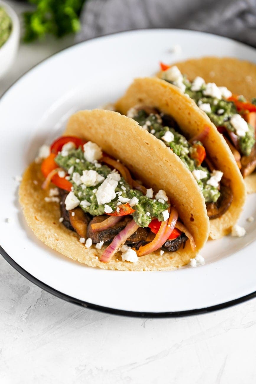 vegetarian tacos with mushrooms, peppers, onions, feta cheese