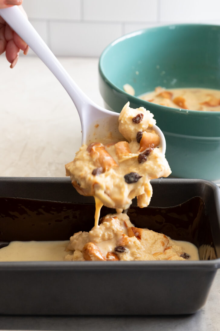 Creamy chicken and wild rice casserole served in a black baking dish, toppings with nuts and dried berries.