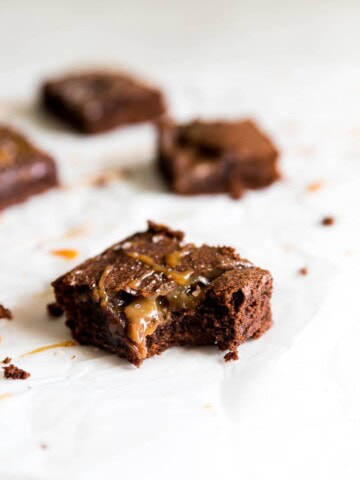 A bite missing out of caramel chocolate brownie